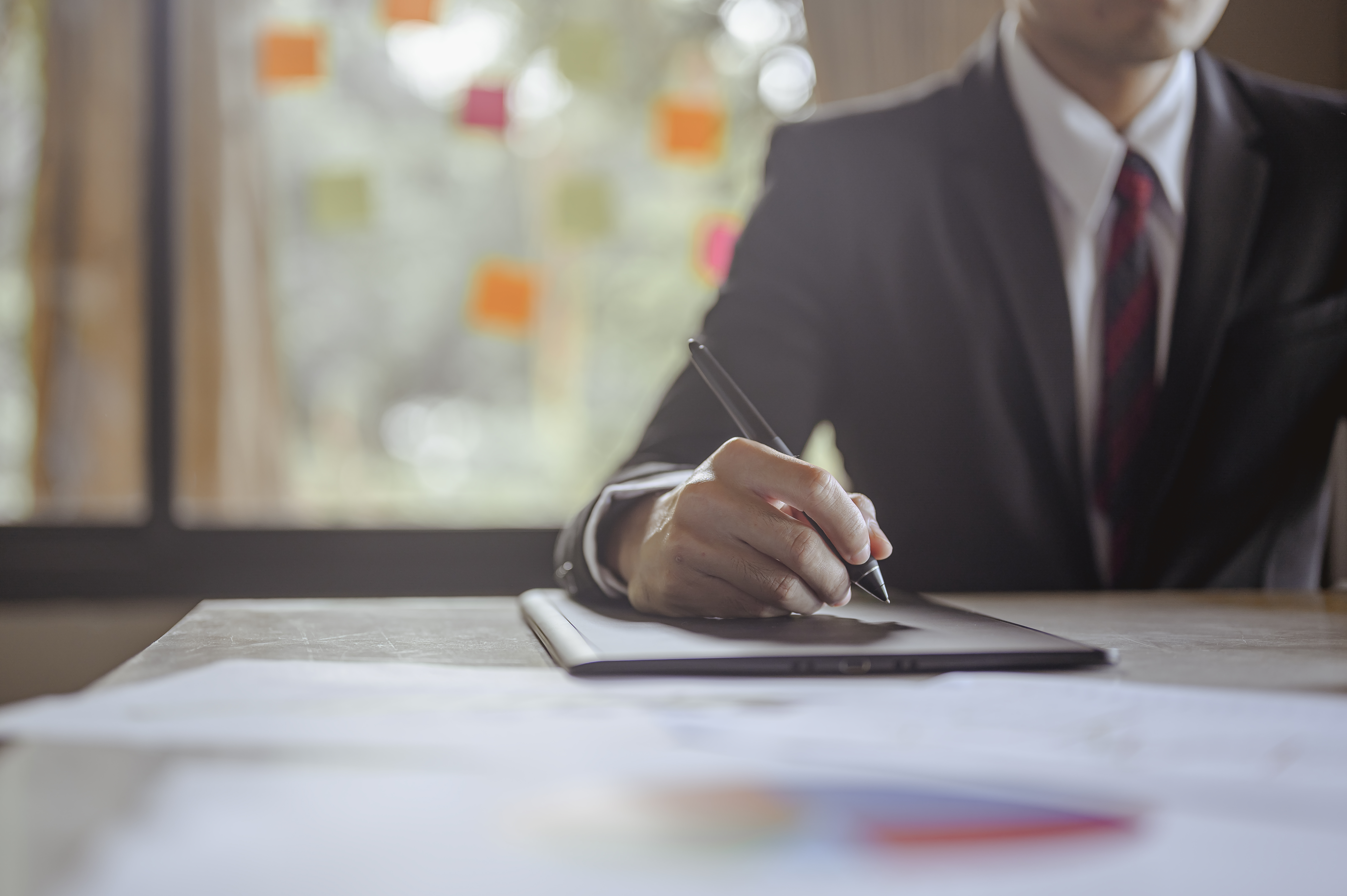 Businessman sitting to working at office desk have a coffee cup beside for efficient work problems and concepts. businessman, working, business, technology, management, planning concepts.