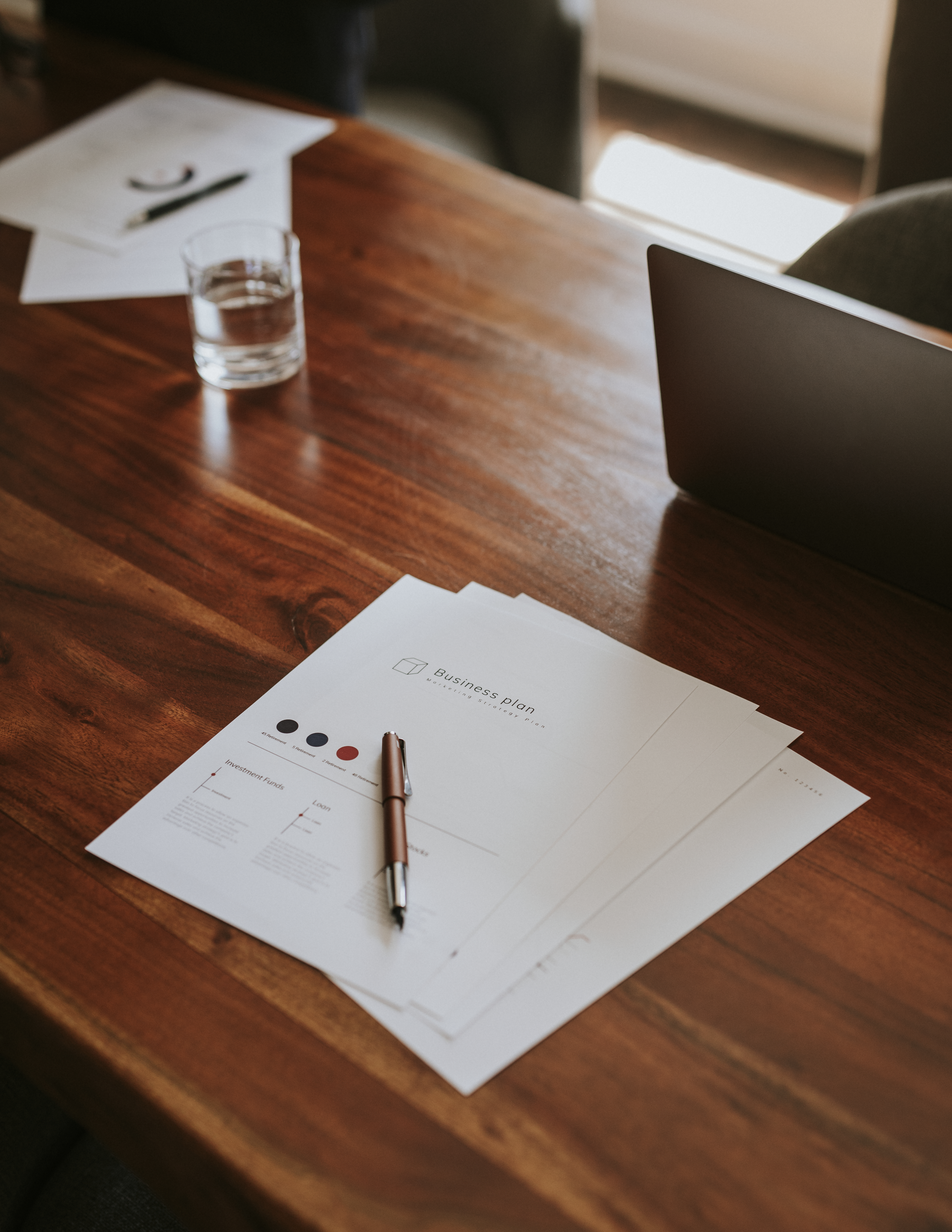 Signing documents in an office on a wooden desk